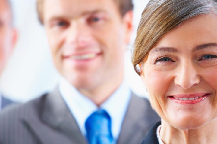 Image of a smiling woman and two men