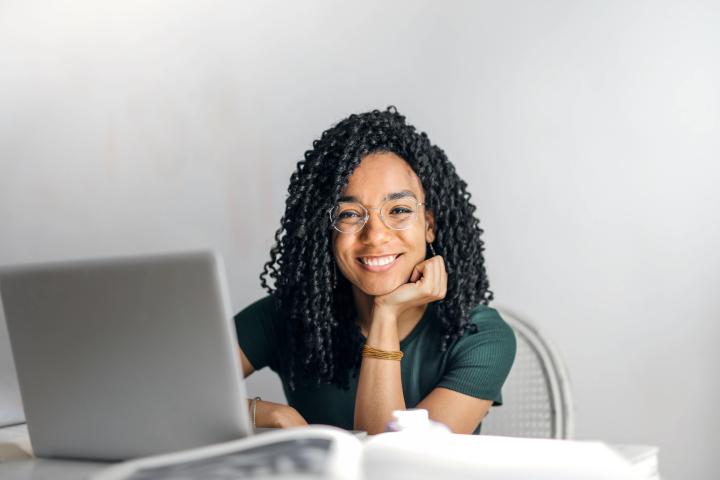 Young woman sitting with her laptop